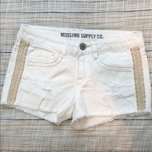 Distressed white denim shorts with crochet detail